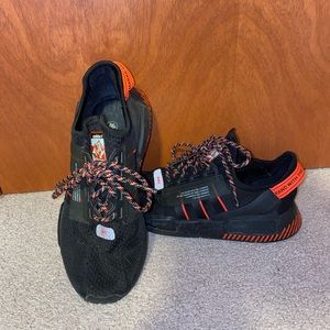 Black and red Adidas NMDs